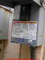 Photograph of the outdoor safety switch for an air conditioning residential system, shown here with the cover open