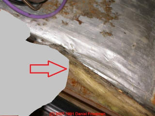 Photo of  leak stains on fiberglass insulation in an air handler (C) InspectApedia.com 