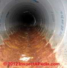 Wet rusted spiral ducts © D Friedman at InspectApedia.com 