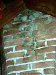 Frost cracked brick chimney viewed in attic (C) DanieL Friedman
