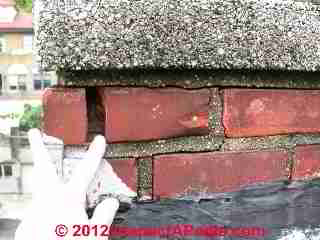 Frost cracked brick chimney viewed in attic (C) DanieL Friedman