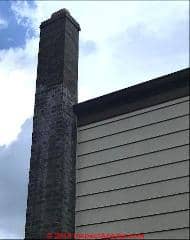 White stains on a brick chimney probably venting LPG or natural gas (C) InspectApedia.com Frank