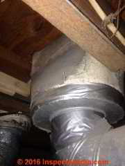Asbestos fabric or reinforced paper on a heating duct and supply register (C) InspectApedia.com  SU 2016