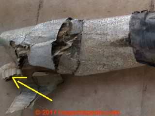 Possible asbestos paper reinforced with jute inside of an HVAC duct (C) InspectApedia.com Tina