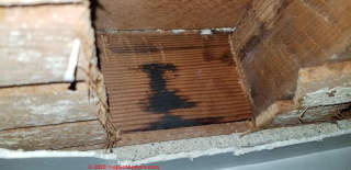 Black tarry stain on wood sill plate is probably not mold (C) InspectApedia.com White
