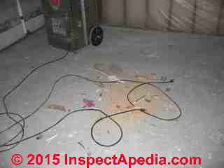 Air scrubber unplugged on a dirty floor (C) Daniel Friedman