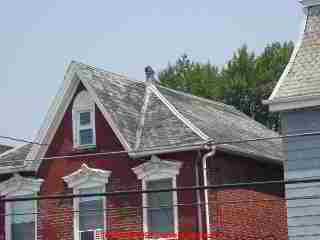 Slate roof temporarily repaired by coating it with tar or roof cement