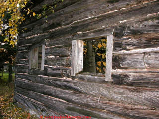 Antique log walls still standing, twisted wood (C) InspectApedia.com Church