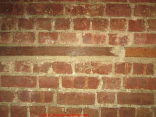 Wood nailer inserted into a structural brick wall (C) Daniel Friedman at InspectApedia.com