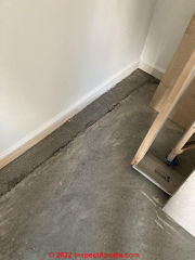 Garage concrete floor showing shrinkage and settling (C) InspectApediad.com JL