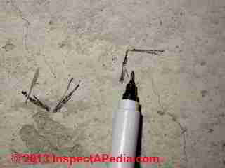 Shrinkage cracks in a floor slab © Daniel Friedman at InspectApedia.com