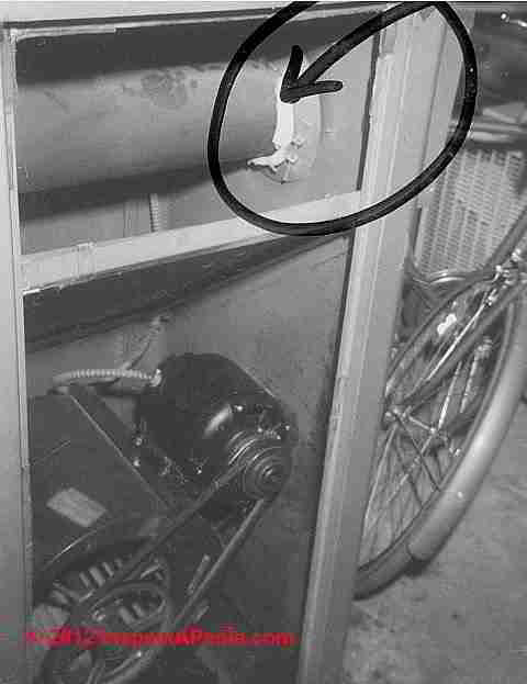Asbestos in furnace blower compartment © D Friedman at InspectApedia.com 
