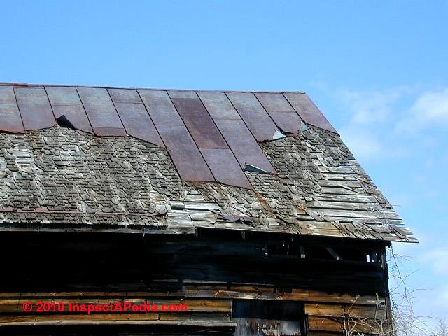 Standing seam metal roof - partly blown off, badly rusted, installed over original wood shingles (C) Daniel Friedman