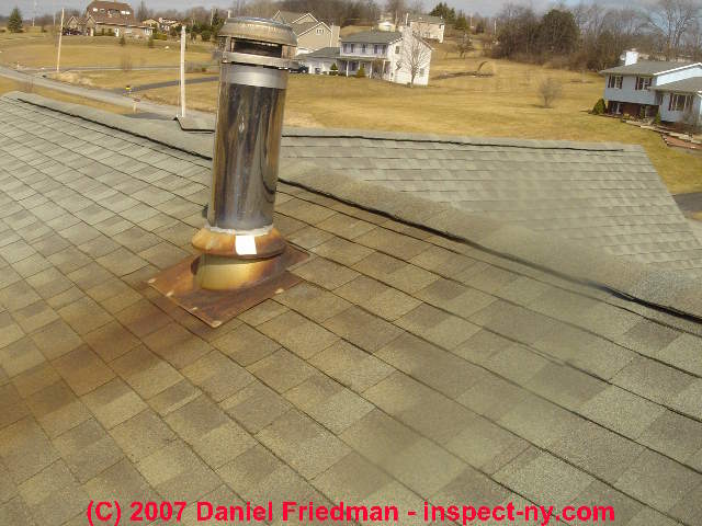 Photograph of reddish brown chimney rust stains on an asphalt shingle roof.