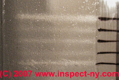 Photograph of parallel airborne particle traces on a microscope slide