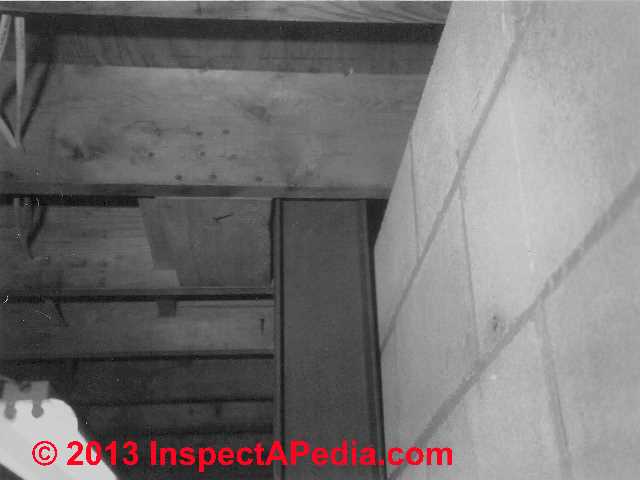 Wavy mortar backfill damage to a block masonry wall © Daniel Friedman at InspectApedia.com