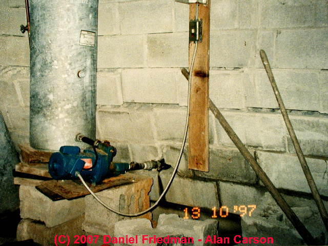 Photograph of a collapsing concrete block foundation wall.