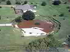 Photograph of a sink hole swallowing a house in Florida