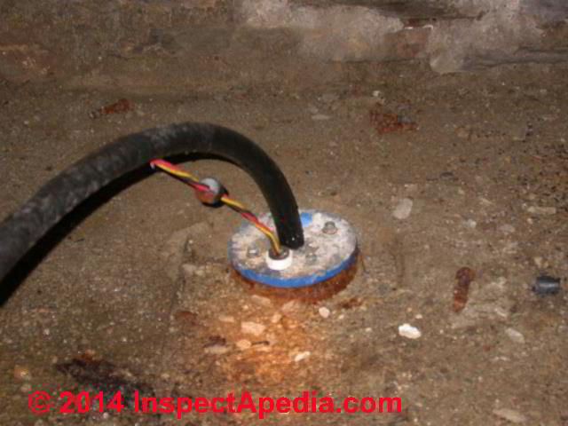 Submersible well pump wiring entering at the well casing top - an indoor well (C) Daniel Friedman