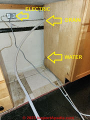 Dishwasher electrical supply, drain line, & water supply all connected to the dishwasher, it is ready to slide into place (C) Daniel Friedman at InspectApedia.com