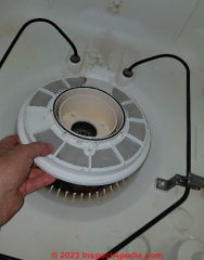 Removing the strainer to gain access to a Maytag dishwasher pump  impeller (C) Daniel Friedman at InspectApedia