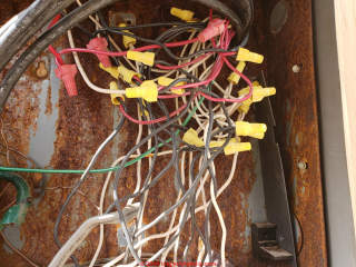 Electrical panel converted to splice box -wiring rats' nest (C) InspectApedia.com Pete Smith