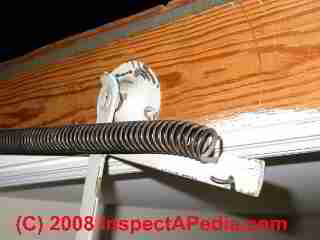 Damaged attic pull down stair arm and spring (C) Daniel Friedman at InspectApedia.com