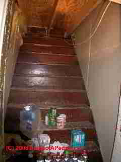 Debris left in attic stairway is a trip hazard and a fire hazard (C) Daniel Friedman ati InspectApedia.com