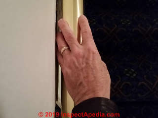 Handrailing too close to wall surface - can't be grasped - unsafe (C) Daniel Friedman at InspectApedia.com