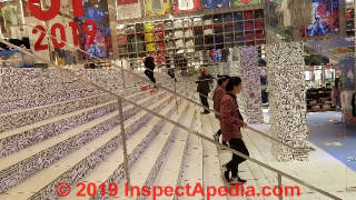 Intermediate handrails installed in a store in New York City (C) Daniel Friedman at InspectApedia.com
