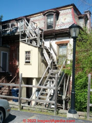 Unsafe wood fire stairs in a New York Home (C) Daniel Friedman at InspectApedia.com