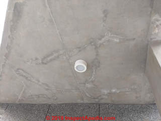 White effloresence stains at fine cracks in a concrete ceiling (C) Inspectapedia.com Shreesha