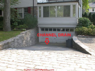 Channel drain installed at the bottom of a drive to keep water out of the garage (C) Daniel Friedman at InspectApedia.com