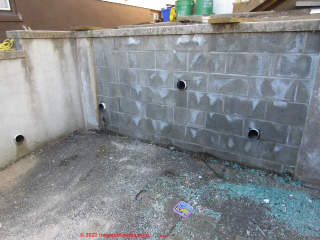 White effloresence salts deposited on new block retaining wall (C) InspectApedia.com Kahn DovBer