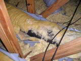 Photograph of  heat-deterioration of Goodman Gray Flex Duct in an attic