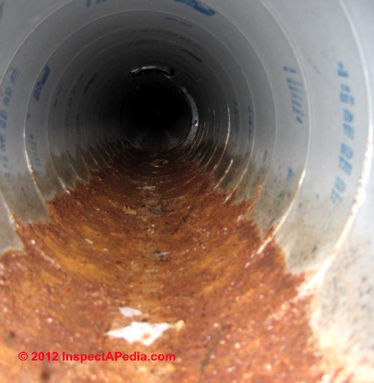 Wet rusted spiral ducts © D Friedman at InspectApedia.com 