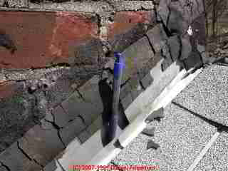 Photograph of a brick chimney cracked exterior, possibly due to heat.