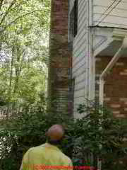 Photograph of a brick chimney separating from the building.