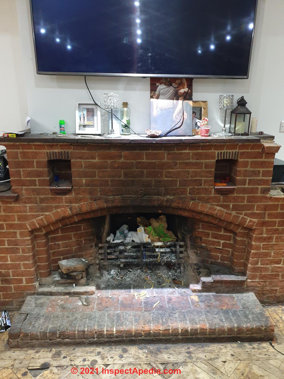 Damaged and unsafe brick masonry fireplace (C) InspectApedia.com Sherlock