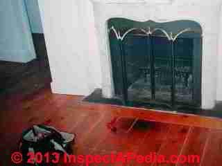 Fireplace hearth missing, burned floor © D Friedman at InspectApedia.com 