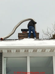 Inserting a flexible stainless steel liner into a damaged chimney venting a gas boiler, Two Harbors MN (C) InspectApedia.com A Church