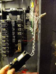 AFCI breaker pulled out of the electrical panel (C) Daniel Friedman at InspectApedia.com