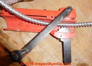 How to cut armored cable (AC) or BX flexible conduit or metal-clad (MC) Cables - NH Firebear (C) InspectApedia 