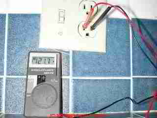 Photographgraph of a mini digital multimeter in use by the author
