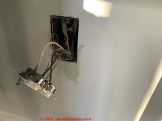 Electrical receptacle left hanging out of the wall (C) InspectApedia.com Kirk
