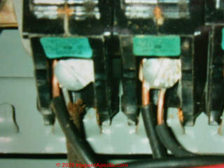 Overheated connector at a double tapped circuit breaker screw (C) InspectApedia.com