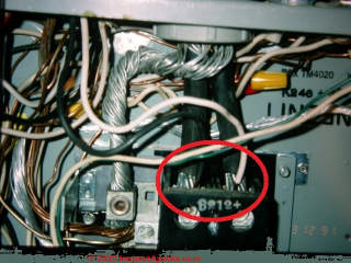 Branch circuit wires double tapped into the main lugs in an electrical panel: Very dangerous (C) Daniel Friedman at InspectApedia.com