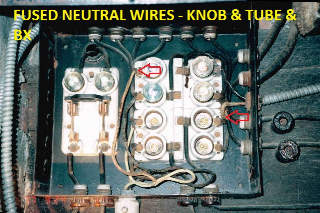 Fused neutral wires in an old fuse panel powering knob and tube and BX (armored cable) wiring (C) Daniel Friedman at InspectApedia.com