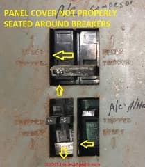 Electrical panel cover not properly seated around circuit breakers - this is an unsafe installation (C) Inspectapedia.com Sweig