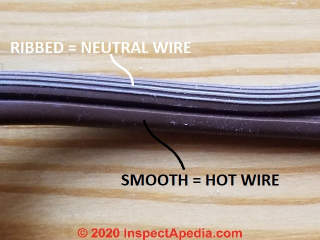 Ribbing along the length of one side of a line cord or zip cord wire marks the neutral wire (C) Daniel Friedman at InspectApedia.com